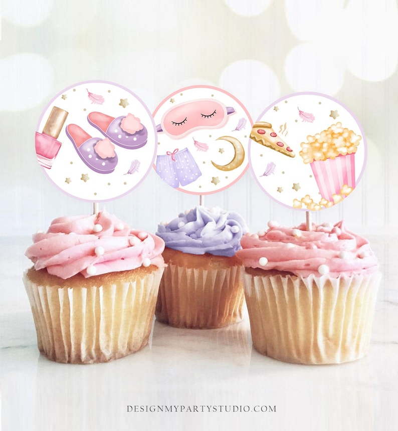 May include: Three round cupcake toppers with images of a sleep mask, slippers, nail polish, pizza, and popcorn. The toppers are on top of cupcakes with pink and purple frosting.