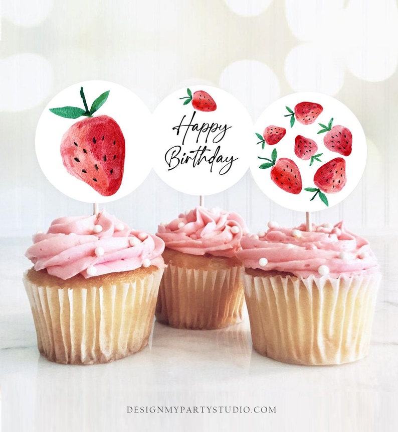 May include: Three cupcake toppers with a watercolor strawberry design. One topper says "Happy Birthday" in black script. Another topper features a single strawberry. The third topper has multiple strawberries.