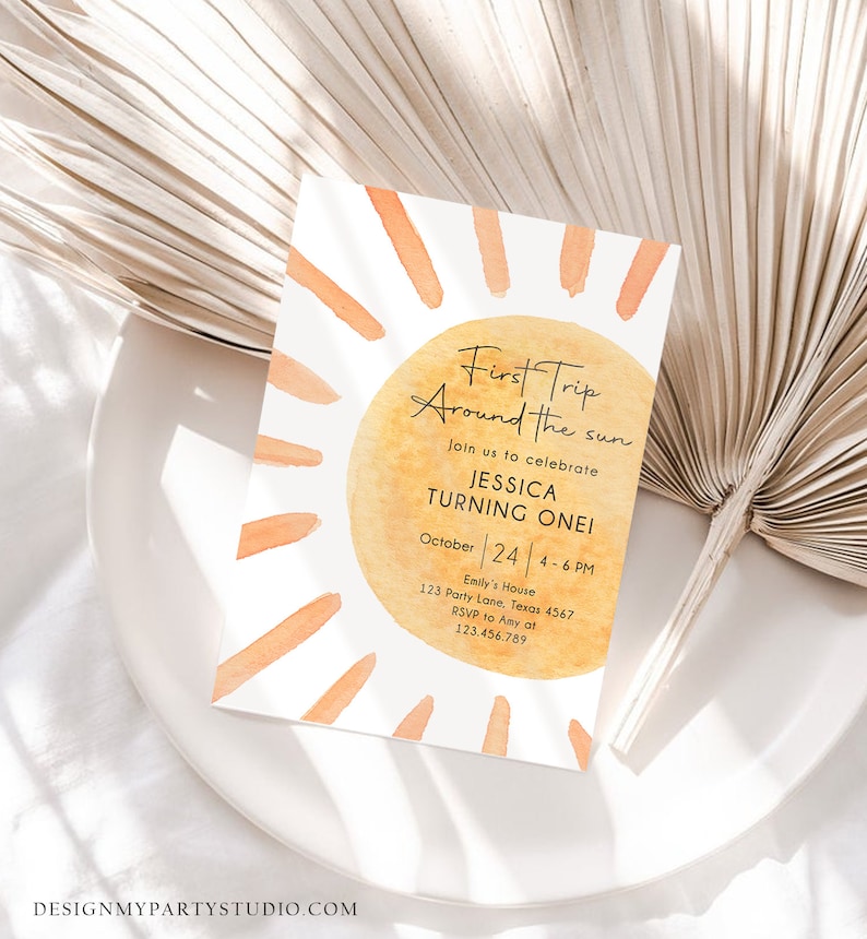 Peut inclure: Une illustration aquarelle d'un soleil avec le texte "First Trip Around the Sun" et "Join us to celebrate Jessica Turning One!" L'invitation comprend &eacute;galement la date "October 24", l'heure "4-6 PM" et l'adresse "Emily's House, 123 Party Lane, Texas 4567".