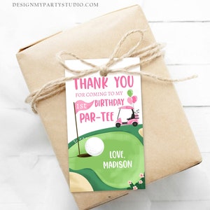 May include: A pink and green golf-themed thank you tag with a golf cart, golf ball, and the text "Thank You for coming to my 1st Birthday Par-Tee Love, Madison".