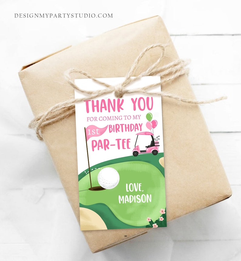 May include: A pink and green golf-themed thank you tag with a golf cart, golf ball, and the text "Thank You for coming to my 1st Birthday Par-Tee Love, Madison".