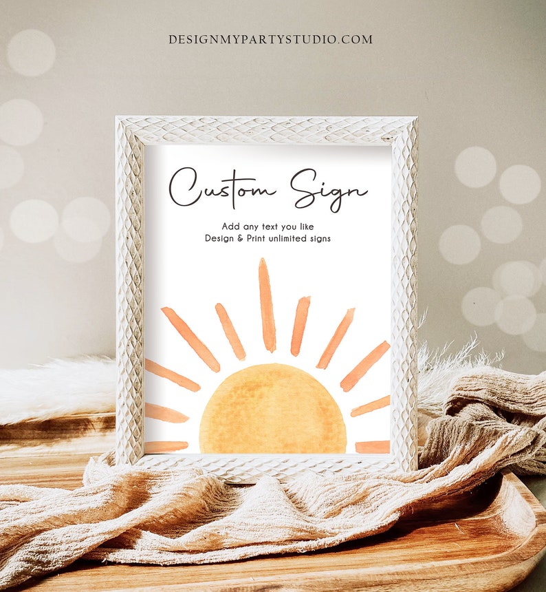 May include: White frame with a white background and a watercolor illustration of a sun with orange rays. The text "Custom Sign" is at the top of the frame. The text "Add any text you like" is below the sun. The text "Design & Print unlimited signs" is below the text "Add any text you like".