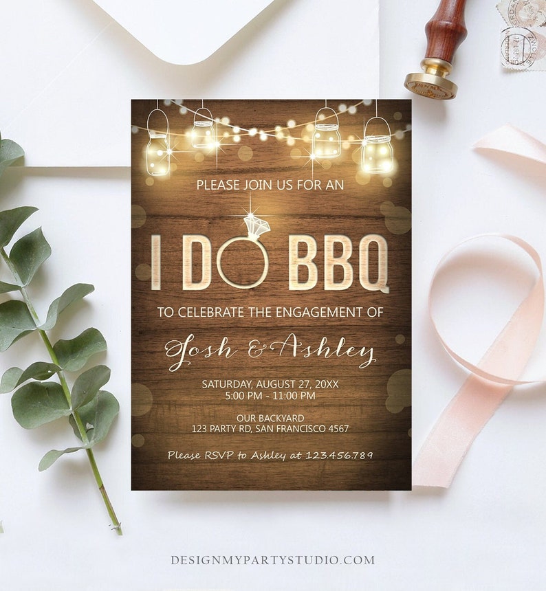 May include: A rustic woodgrain background with a string of lights and mason jars. The text "I DO BBQ" is in large letters with a diamond ring in the "O". The text "To celebrate the engagement of Josh & Ashley" is below the main text. The date, time, and location of the event are listed below the names.