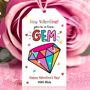 May include: A white gift tag with a colourful diamond illustration and the text "Hey Valentine! You're a true GEM. Happy Valentine's Day! XOXO Olivia."
