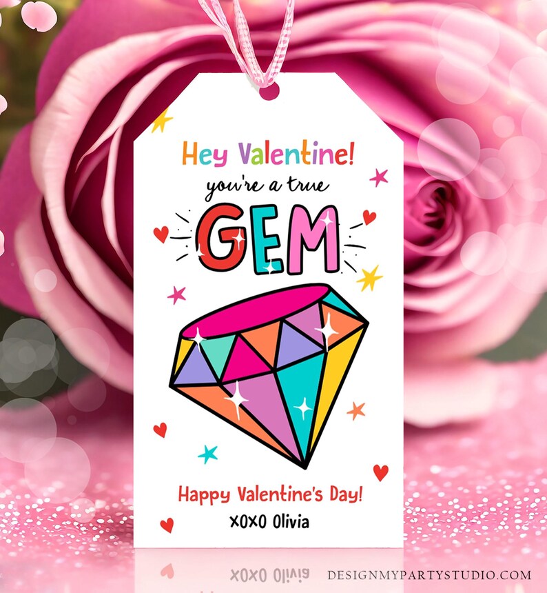 May include: A white gift tag with a colourful diamond illustration and the text "Hey Valentine! You're a true GEM. Happy Valentine's Day! XOXO Olivia."
