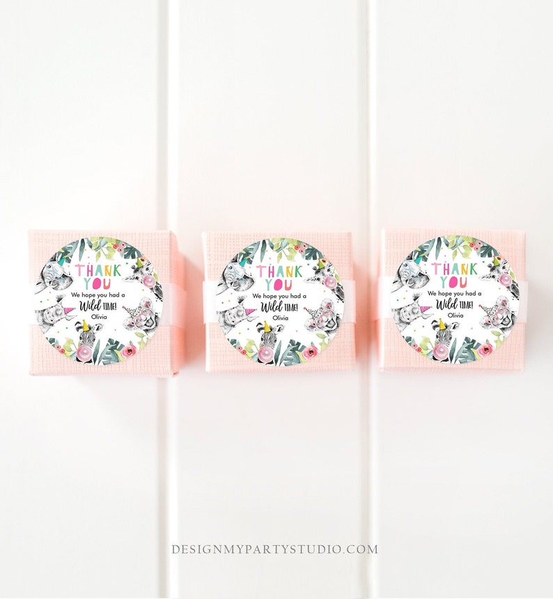 May include: Three small, light pink gift boxes with white bands. Each box has a round sticker with the text "THANK YOU" and "We hope you had a Wild Time!" with the name "Olivia". The stickers feature watercolor animal illustrations.