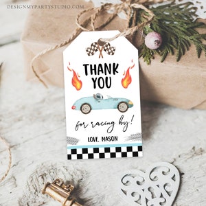 May include: A blue and white thank you tag with a cartoon race car, checkered flags, and flames. The text reads "Thank You for racing by! Love, Mason".