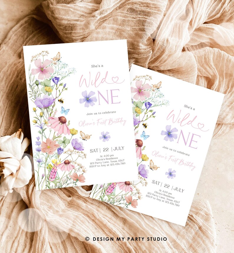 May include: A printable invitation for a first birthday party. The invitation features a watercolor floral design with butterflies and the text "She's a Wild One" in pink and purple. The invitation includes the date, time, location, and RSVP information.