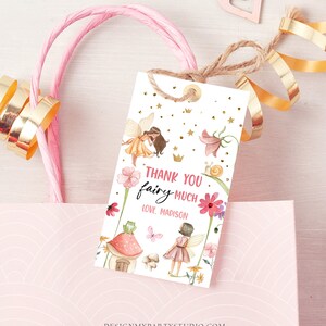 Puede incluir: Muchas gracias hada, con amor Madison. Una etiqueta de agradecimiento blanca con ilustraciones de hadas rosas y doradas, flores y estrellas. La etiqueta est&aacute; atada con un cordel.