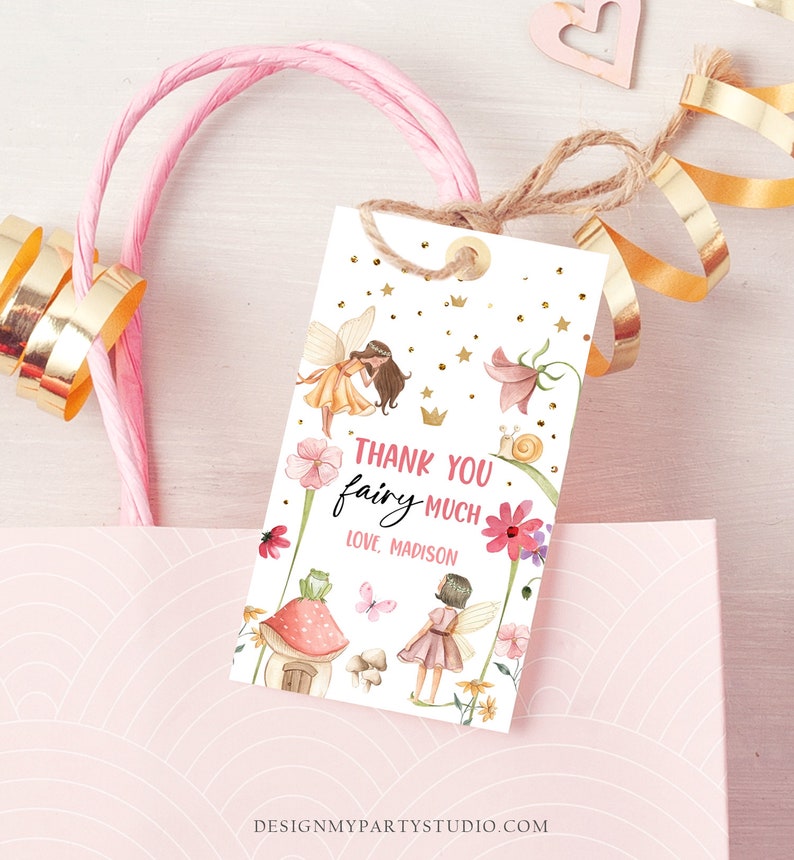 Puede incluir: Muchas gracias hada, con amor Madison. Una etiqueta de agradecimiento blanca con ilustraciones de hadas rosas y doradas, flores y estrellas. La etiqueta est&aacute; atada con un cordel.