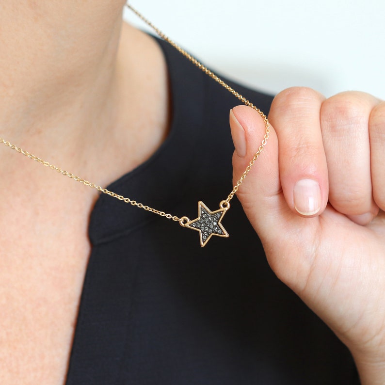 Golden plated star necklace with black sparkle centre