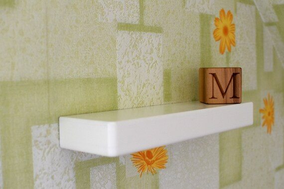 white floating shelves nursery