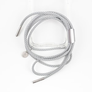 May include: A clear phone case with a gray and white patterned phone strap. The strap has a silver metal clasp and a silver charm.