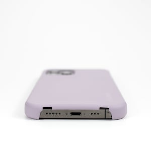 May include: A lavender phone case with a cutout for the camera lens and a charging port.