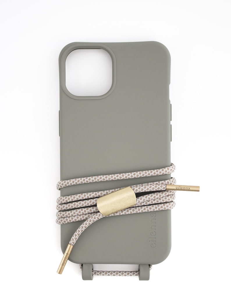 May include: A gray phone case with a patterned rope strap. The case has a cutout for the camera and the brand name "eilenna" is printed on the case and the strap hardware. The strap is tan and white.