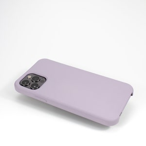 May include: A lavender silicone phone case with a black camera lens cutout.