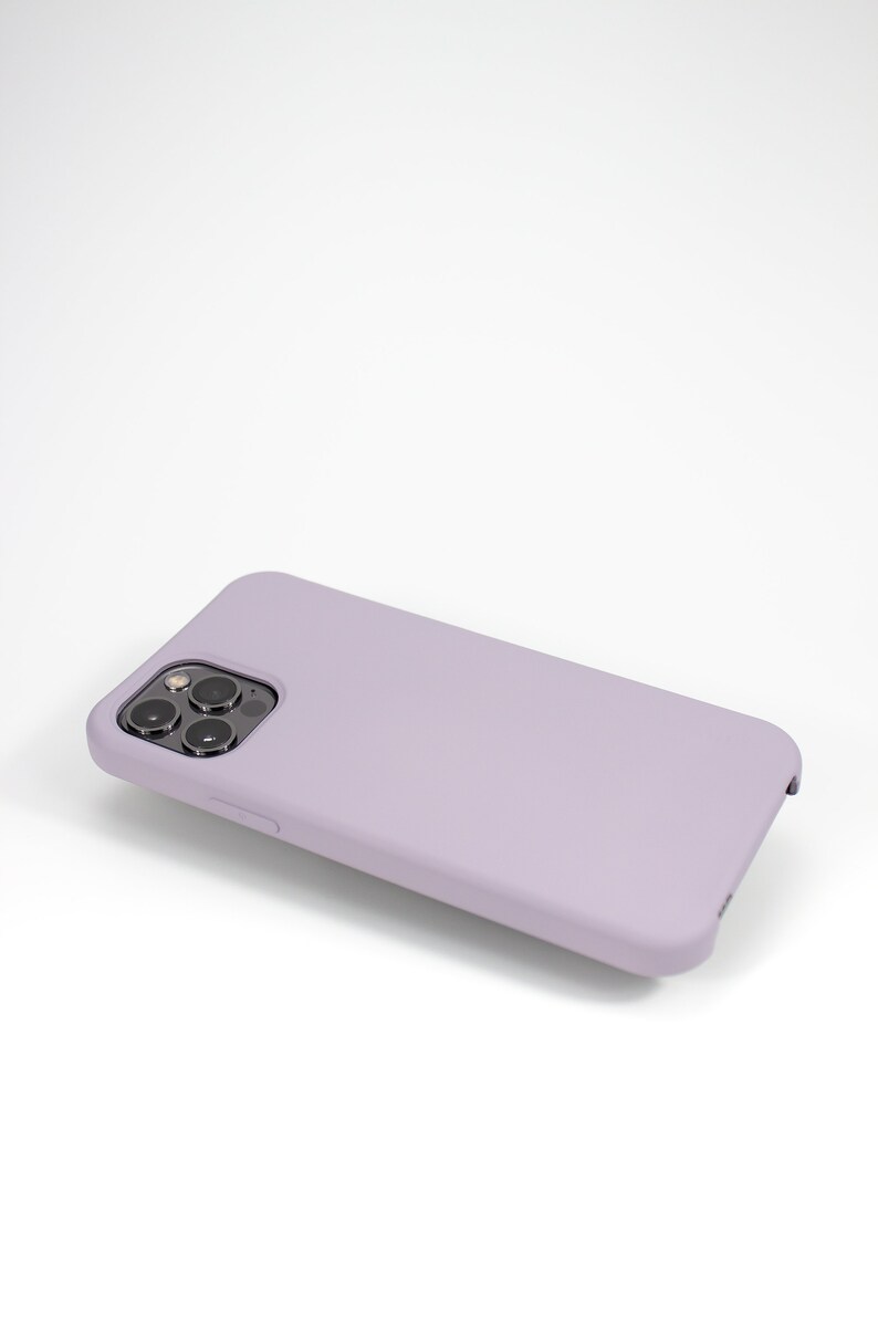 May include: A lavender silicone phone case with a black camera lens cutout.