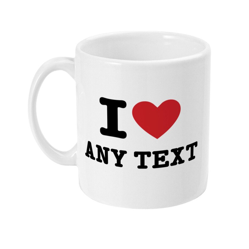 May include: White ceramic mug with a black "I love" design and a red heart. The text "ANY TEXT" is printed below the heart.
