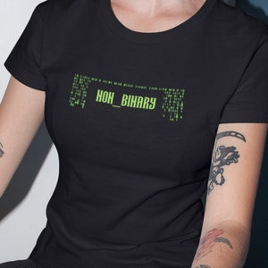 May include: A black t-shirt with a green graphic that reads "NON_BINARY" in a code-like font.