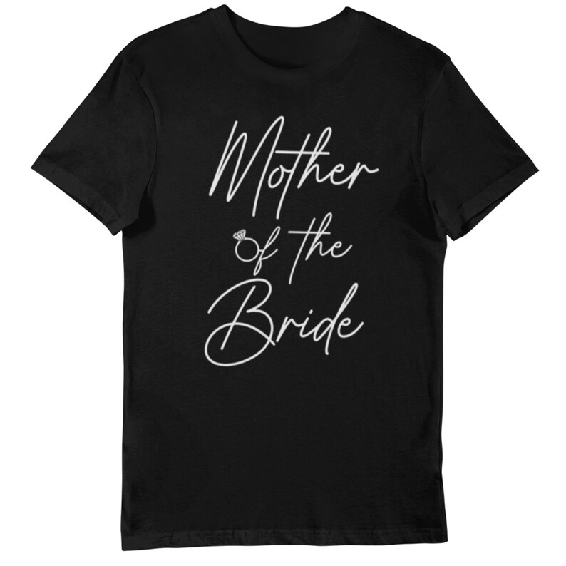 May include: Black t-shirt with white cursive text that reads "Mother of the Bride". The text includes a small ring graphic between "Mother" and "of the". A classic crew neck tee.