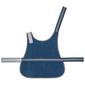 May include: A blue denim dog vest with reflective strips. The vest has a single strap that goes over the dog's head and a buckle closure around the chest.