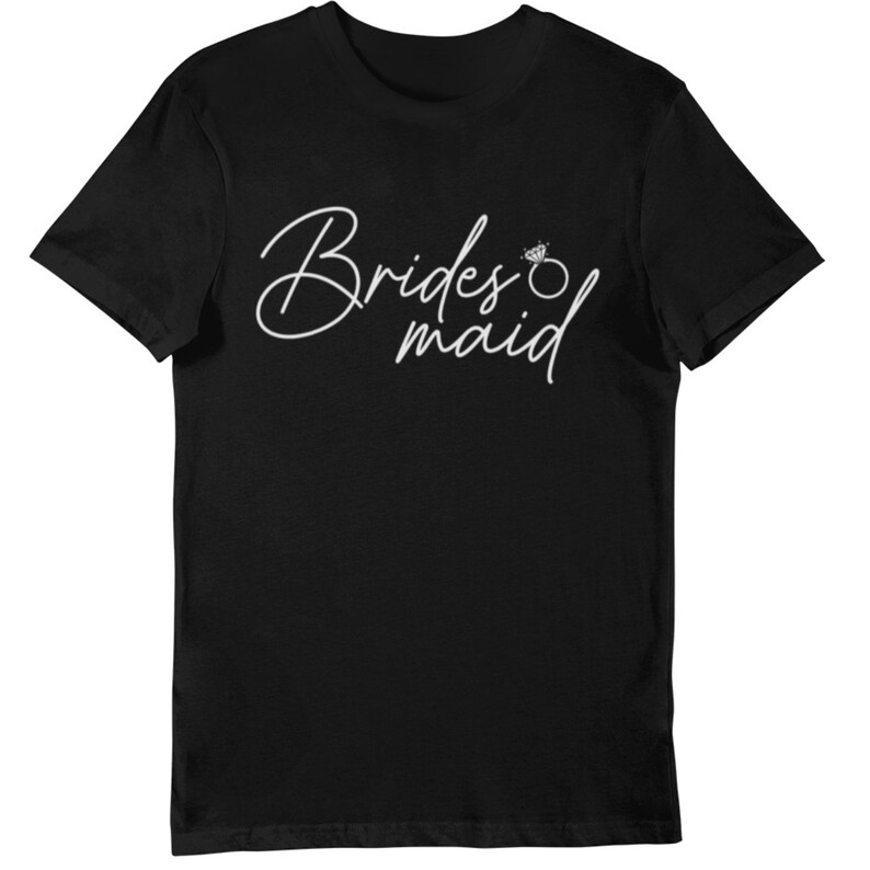 May include: Black t-shirt with the words "Bridesmaid" in a white script font, accompanied by a diamond ring graphic. The design is centered on the front of the shirt, offering a simple yet elegant look.