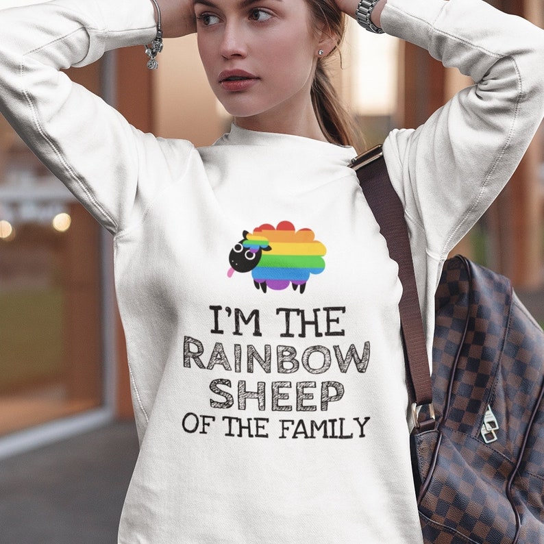 May include: White sweatshirt with a rainbow sheep graphic and the text "I'm the rainbow sheep of the family."