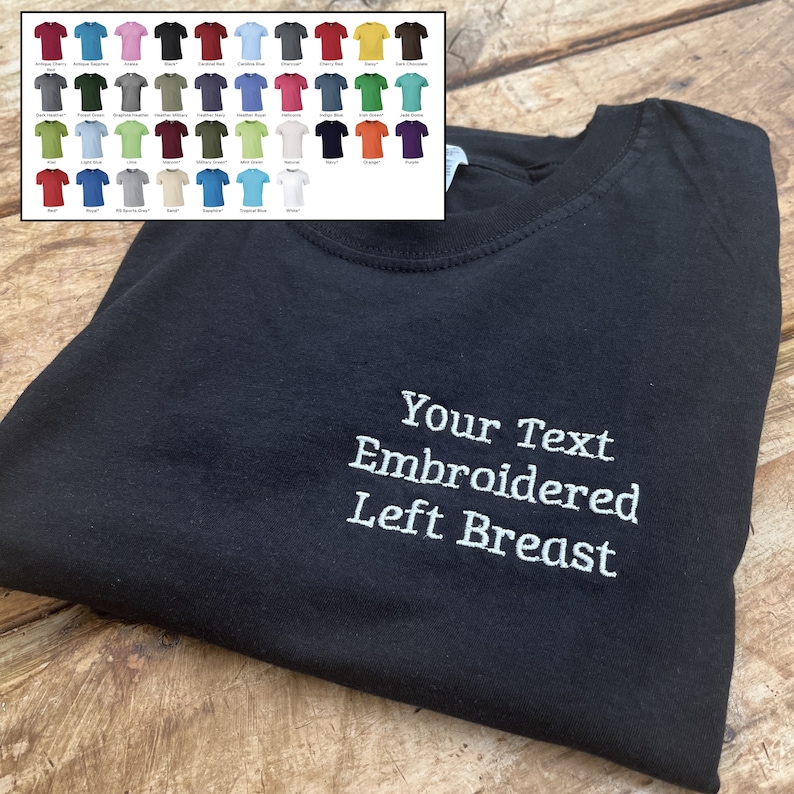 May include: Black t-shirt with white embroidery that says "Your Text Embroidered Left Breast".