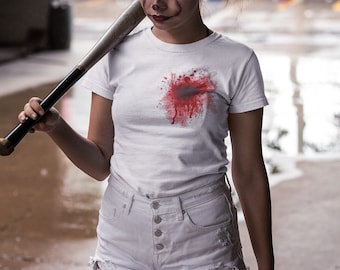 May include: A white t-shirt with a red blood splatter design on the front. The shirt is being worn by a person holding a baseball bat.