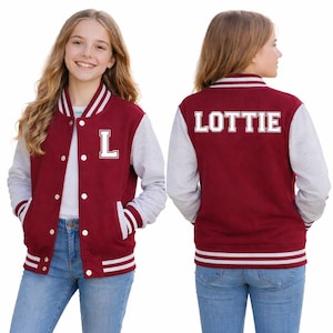 May include: A maroon and grey letterman jacket with white stripes and detailing. The front features a large white "L", and the back displays the name "LOTTIE" in white block letters. The jacket has a button-up front and grey sleeves.
