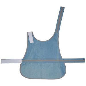 May include: A light blue denim dog vest with reflective gray trim and a white strap. The vest has a single strap that goes over the dog's head and a buckle closure around the chest.