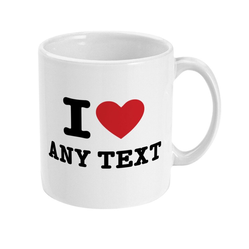May include: White ceramic mug with a black "I love" design and a red heart. The text "ANY TEXT" is printed below the heart.