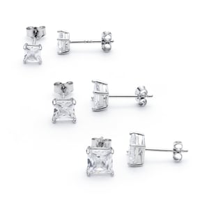 May include: Three pairs of silver stud earrings with clear square-shaped cubic zirconia stones.