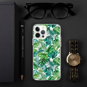May include: A clear phone case with a tropical leaf pattern. The case has a white background with green and blue leaves.