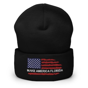 May include: Black beanie with a red, white, and blue American flag and the text "Make America Florida" embroidered on the front.