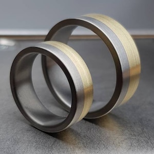 Zirconium wedding set with a wide Gold rail. One of a kind combination! Customizable, hypoallergenic and very resistant.