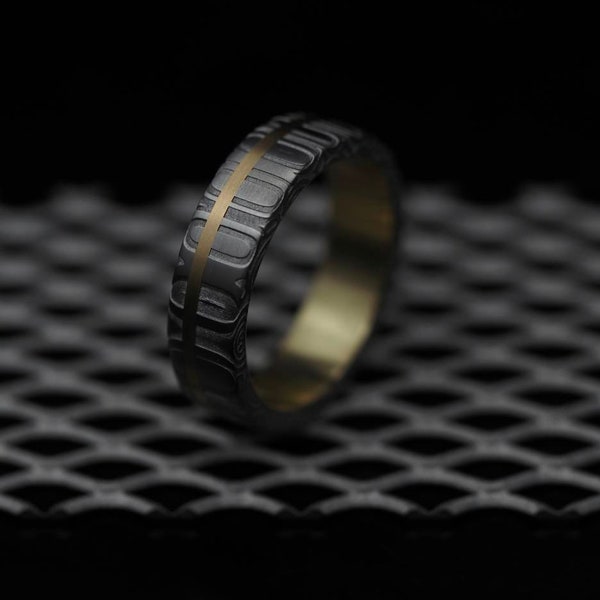 Stunning Damascus Steel ring with a Gold rail lined in Gold. Customizable and hypoallergenic.