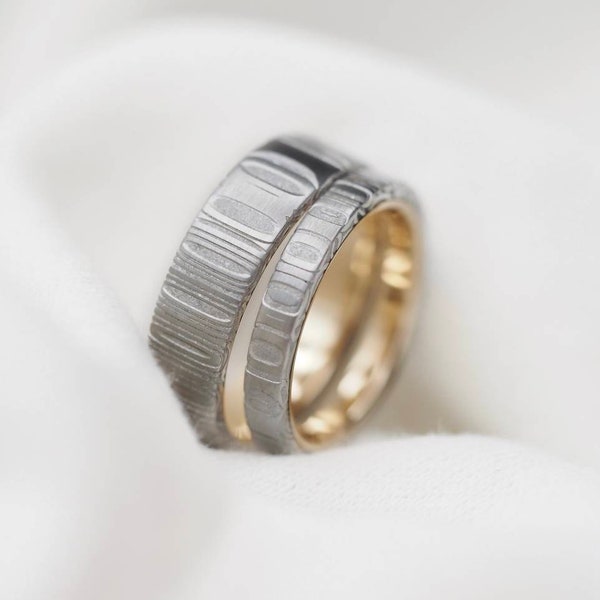 Celtic Damascus Steel rings lined in Gold. Customizable and hypoallergenic.