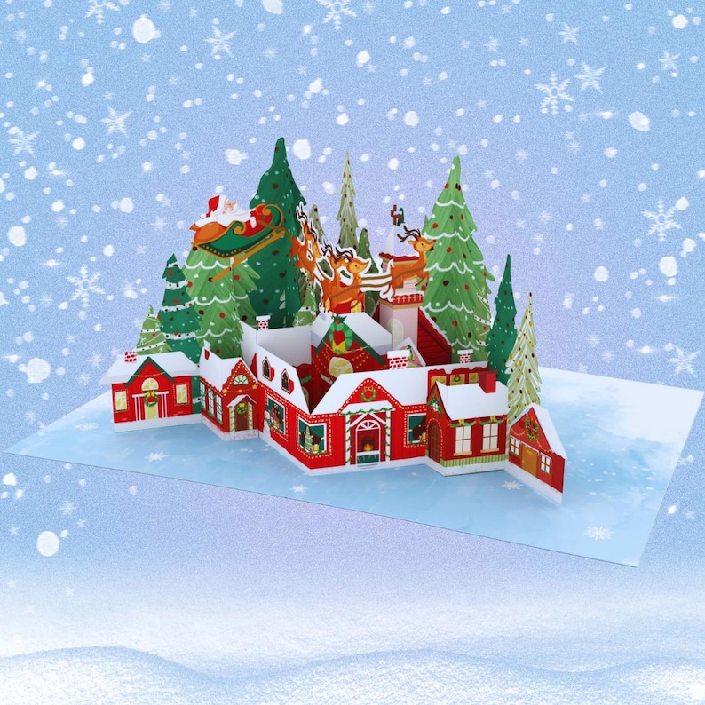 May include: A 3D pop-up Christmas card featuring a snowy village with red houses, green trees, and Santa Claus flying in his sleigh.