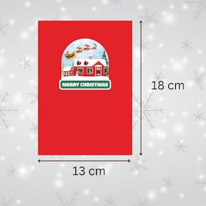 May include: Red Christmas card with a snow globe image of a house with Santa Claus flying over it. The card measures 5.1 inches by 7.1 inches and says "Merry Christmas".