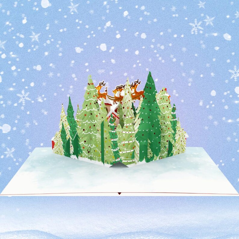 May include: A 3D pop-up card featuring a winter scene with a red and white house, green pine trees decorated with lights and ornaments, and a sleigh pulled by reindeer flying through the air. The card is set against a blue background with white snowflakes.