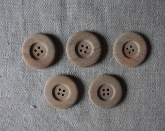 May include: Five wooden buttons with four holes each. The buttons are brown and have a natural wood finish.