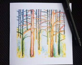 May include: A square art print featuring a colorful forest scene. The artwork depicts tall, slender trees with orange and brown trunks, set against a backdrop of blue and yellow hues. A black pen rests on the side.