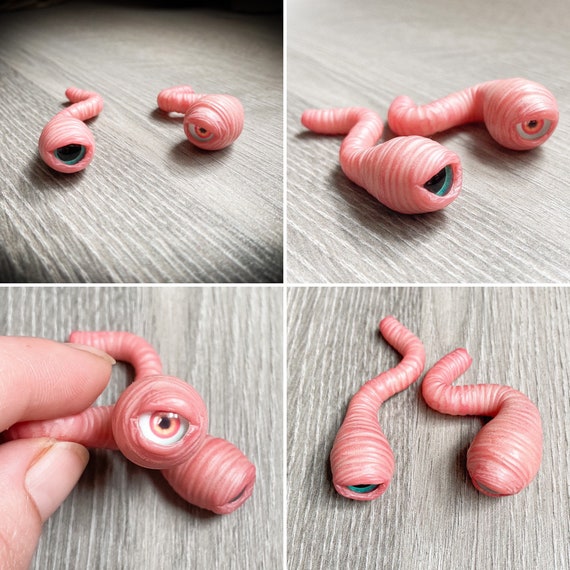 A handmade eyeball-worm creature ornament that's equal parts horrifying and endearing — 490 favorites on a $7.50 item is an insane demand signal for how shareable this is.