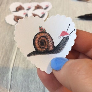 Handmade stickers with snail illustration