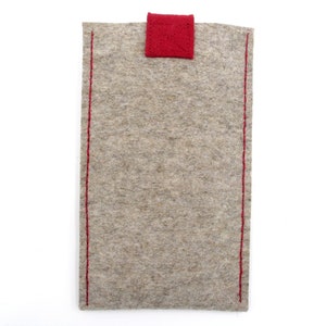 May include: A gray felt pouch with red stitching and a red felt flap.