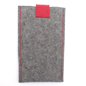 May include: A grey felt phone case with red stitching and a red felt flap.