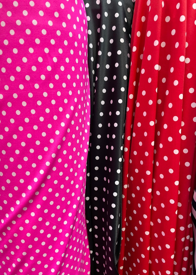 May include: Three fabric swatches with white polka dots on different colored backgrounds. The swatches are pink, black, and red.