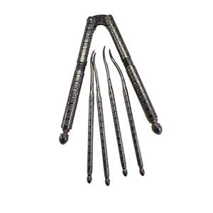 May include: A silver-colored nutcracker with ornate detailing and a set of four matching picks. The nutcracker has a lever design with decorative patterns along the handles and a rounded end. The picks are slender and curved, designed for extracting nuts.