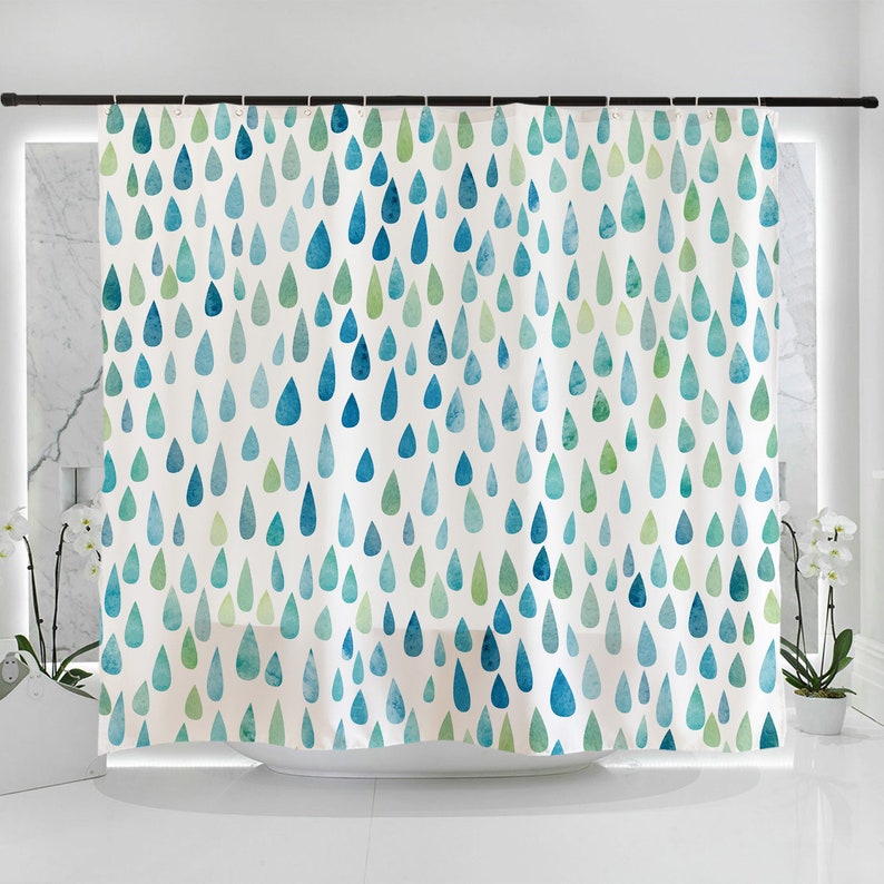May include: A white shower curtain with a blue and green watercolor raindrop pattern.